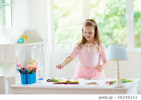 Art and crafts for kids. Girl doing homework. 50249151