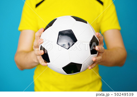 Man is socccer fan in yellow t-shirt with soccer ball 50249539