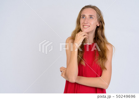 Portrait of young happy blonde woman thinking and looking up 50249696