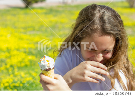 Dissatisfied unhappy teen girl eats tasteless ice 50250743