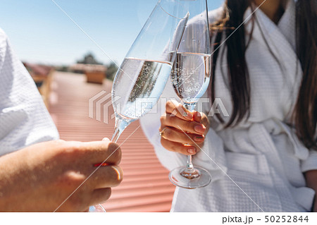 flirting couple with sparkling wine on a roof 50252844
