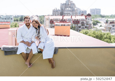 flirting couple with sparkling wine on a roof flirting couple with sparkling wine on a roof 50252847