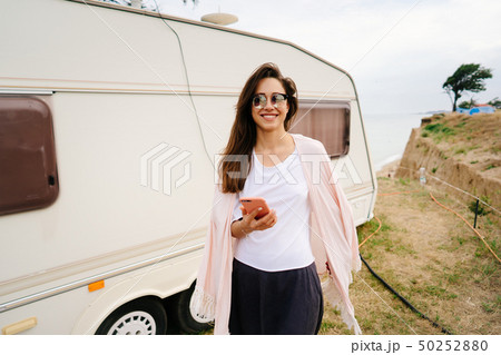 Beautiful, young girl posing on a wild beach sailor at the van 50252880