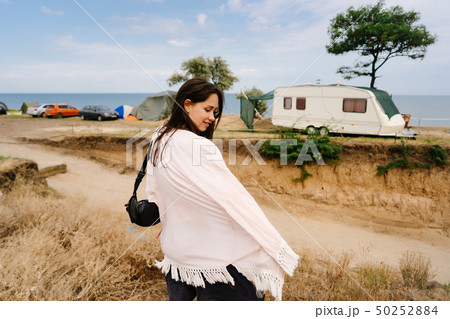 Beautiful, young girl posing on a wild seashore 50252884