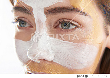 Upper face of pretty woman with cosmetic mask 50252885