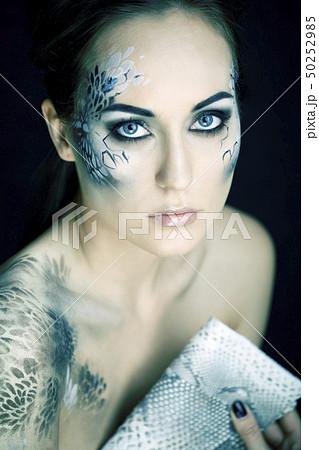 fashion portrait of pretty young woman with creative make up like a snake, fashion victim with fashion portrait of pretty young woman with creative make up like a snake, fashion victim with 50252985