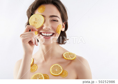 Happy smiling woman with many lemon pieces 50252986
