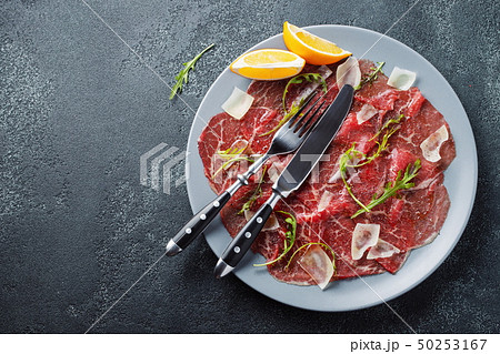 Marbled beef carpaccio with arugula. 50253167