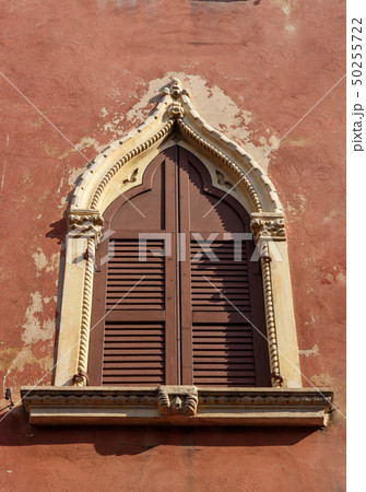 Arched window with wooden shutters of medieval 50255722