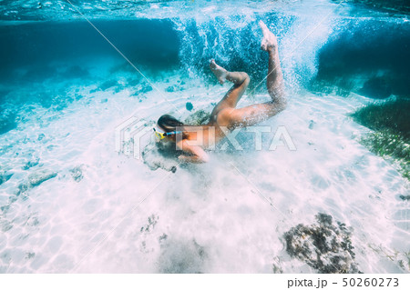 Naked woman with mask swim and dive in sea Naked woman with mask swim and dive in sea 50260273