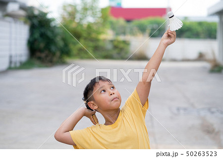 Asian kid boy playing badminton at home Asian kid boy playing badminton at home 50263523