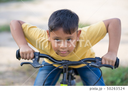 asian kid boy ride bicycle in nature asian kid boy ride bicycle in nature 50263524