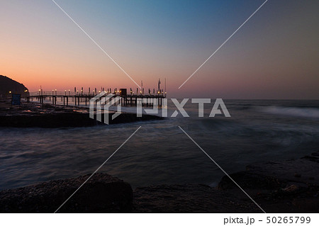 Beautiful view on coast pier on rocky beach. 50265799