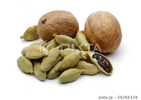 Nutmeg and cardamom pods isolated on white Nutmeg and cardamom pods isolated on white 50266338