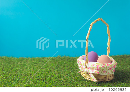 Easter eggs in a basket weave wood on the green 50266925
