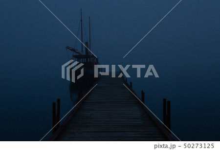 Boat at the pier in time of fog by night 50273125