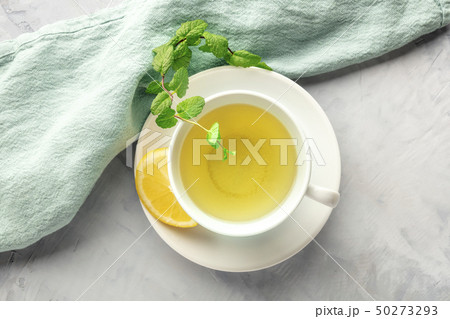 A photo of a cup of green tea with lemon and mint leaves, shot from above with copy space A photo of a cup of green tea with lemon and mint leaves, shot from above with copy space 50273293