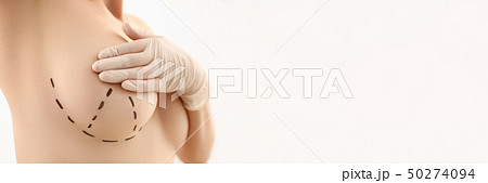 Female hand in gloves holding breast closeup Female hand in gloves holding breast closeup 50274094