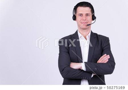 Portrait of handsome businessman as call center representative with arms crossed 50275169