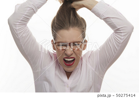 Businesswoman grins her teeth tearing hair Businesswoman grins her teeth tearing hair 50275414