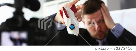 Businessman hold rocket in hand closeup Businessman hold rocket in hand closeup 50275416