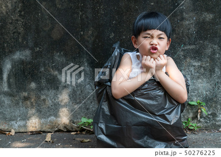 Little girl is acting in garbage bag 50276225