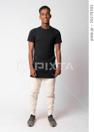 Full body shot of young happy African man smiling Full body shot of young happy African man smiling 50276382