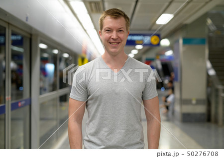 Young happy tourist man smiling at the underground train station in Bangkok 50276708