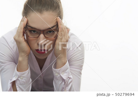 Stressed woman in pink blouse holding her head Stressed woman in pink blouse holding her head 50279694
