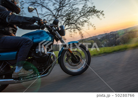 Moto racer riding on forest road. Moto racer riding on forest road. 50280766