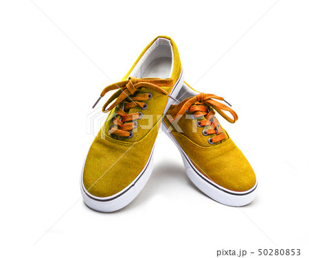 A pair of yellow color canvas shoes isolated on A pair of yellow color canvas shoes isolated on 50280853