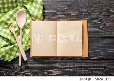 open recipe book, on dark wooden background, view open recipe book, on dark wooden background, view 50281371