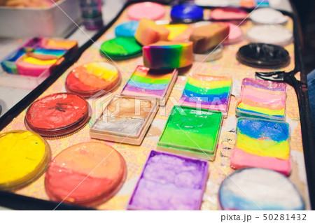 Artistic equipment: paint, brushes and art palette on wooden table. 50281432