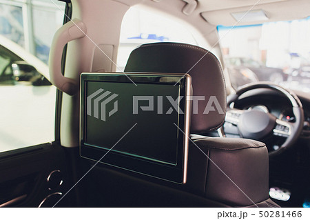Car inside. Interior of prestige luxury modern car. Three TV displays for passenger with media 50281466