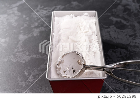Metal spoon of vanilla ice cream on black Metal spoon of vanilla ice cream on black 50281599