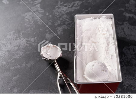 Metal spoon of vanilla ice cream on black 50281600