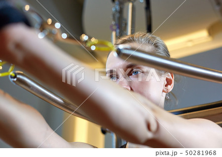 gym woman pilates stretching sport in reformer bed instructor girl. Selective focus on hands gym woman pilates stretching sport in reformer bed instructor girl. Selective focus on hands 50281968