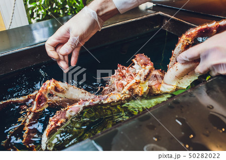 Chef cook restaurant in white uniform is holding fresh big kamchatka crab. Concept healthy food Chef cook restaurant in white uniform is holding fresh big kamchatka crab. Concept healthy food 50282022