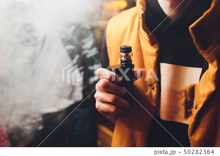Man is smoking electronic cigarette or vaporizer. Man is smoking electronic cigarette or vaporizer. 50282364