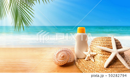 Sunblock with straw hat on a tropical beach 50282794