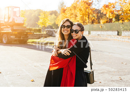 Portrait two beautiful happy girlfriends in the park. 50283415