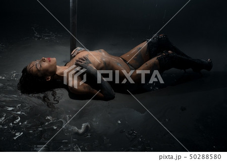 Brunette topless lying on the floor in mud view 50288580