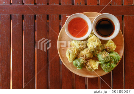 Yellow and green dumpling dim sum stuffed with 50289037