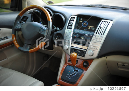 Modern luxury prestige car interior, dashboard, steering wheel. Perforated leather, wooden interior. Modern luxury prestige car interior, dashboard, steering wheel. Perforated leather, wooden interior. 50291897