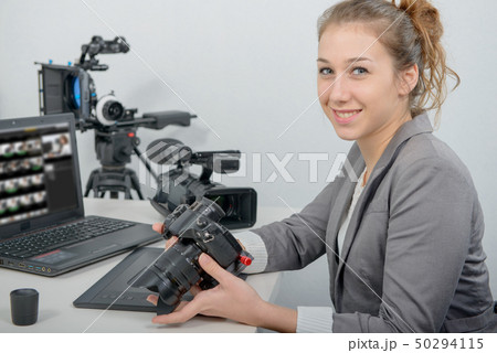 pretty young woman photographer with camera in pretty young woman photographer with camera in 50294115