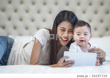 Mother and baby waching a cartoon Mother and baby waching a cartoon 50297720