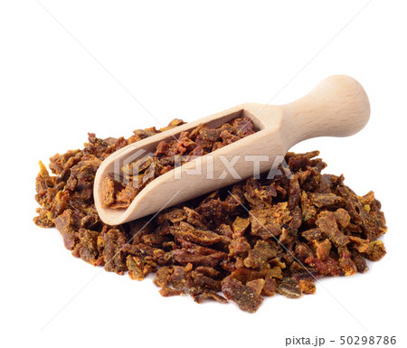 Propolis granules in a wooden shovel are isolated 50298786