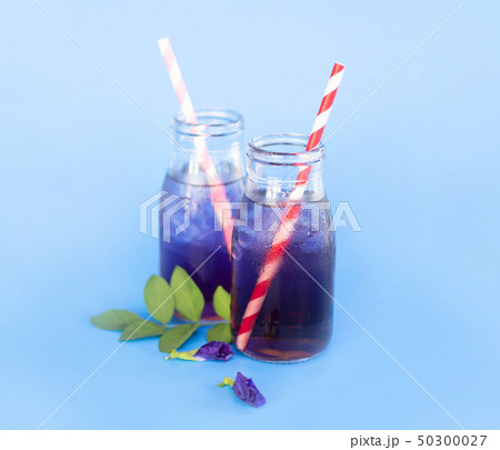 Butterfly pea juce in grass bottle with leaf Butterfly pea juce in grass bottle with leaf 50300027