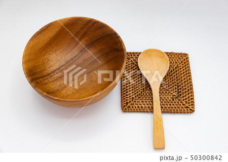 Cup and spoon, wood pattern, placed on a white Cup and spoon, wood pattern, placed on a white 50300842