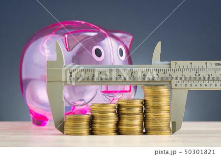 vernier caliper and stacking coins on desk 50301821